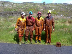 Cavers covered in mud